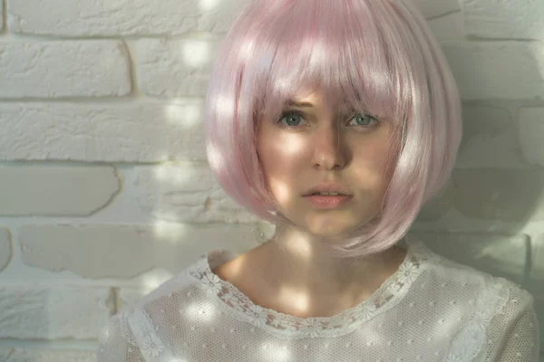 Girl posing in pink wig