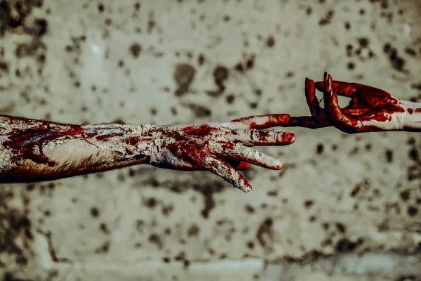 Halloween two zombie touching fingers on concrete wall — Stock Photo, Image