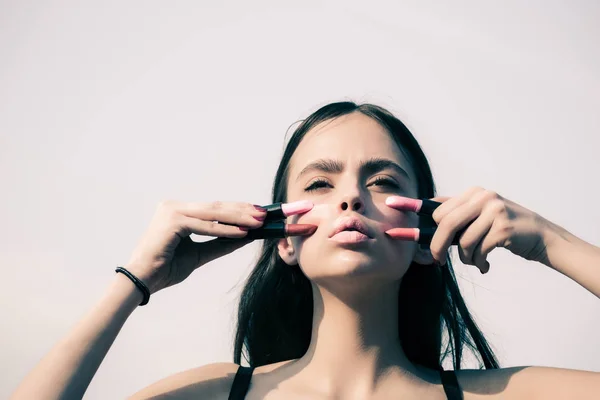 Mujer posando con labios rosados y pintalabios en el cielo blanco —  Fotos de Stock