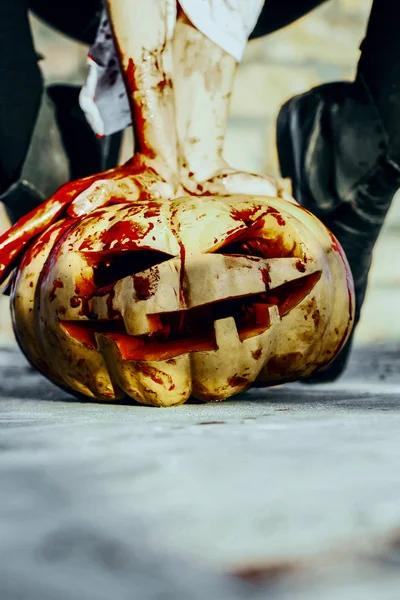 Halloween pumpkin with red blood on cement background — Stock Photo, Image