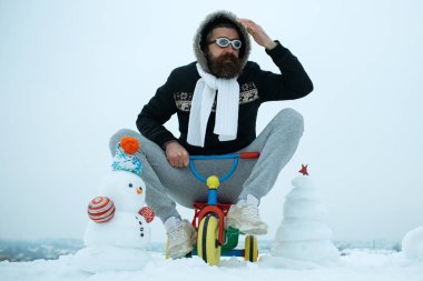 Üç tekerlekli bisiklet üzerinde karlı manzara kişini