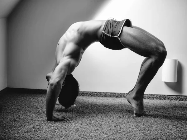 Muscular yoga man in bridge position