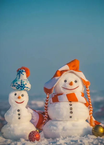 Snowmen in hats on natural background — Stock Photo, Image