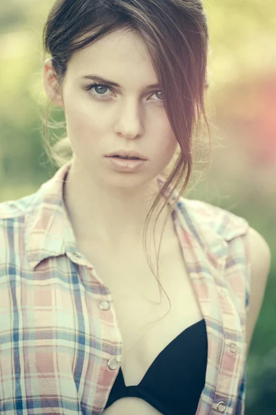 Woman in black bra under plaid shirt. — Stock Photo, Image