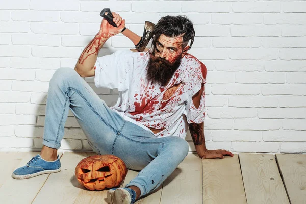 Halloween zombie vousatých zakrvácený muž s dýní a sekera — Stock fotografie