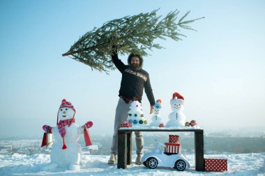 Mutlu adam mavi gökyüzü Xmas ağacı yetiştirme