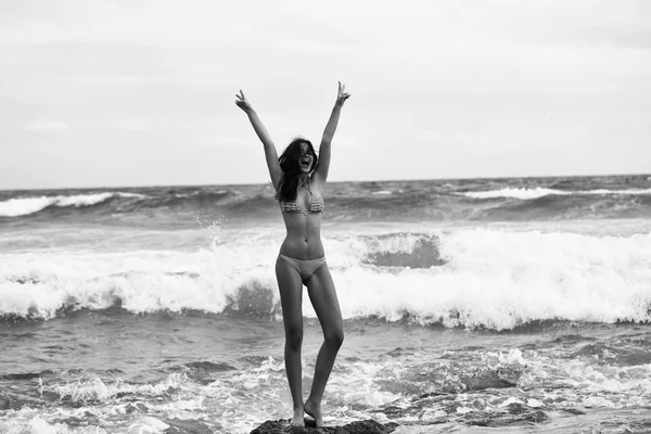 Pretty girl in sexi yellow swimsuit standing on rock — Stock Photo, Image