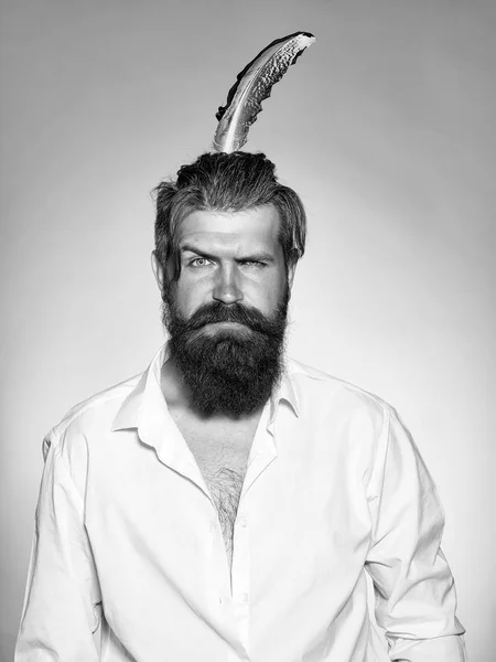 Bearded man with feather in hair — Stock Photo, Image