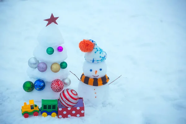 Snowman with smiley face in hat and scarf — Stock Photo, Image