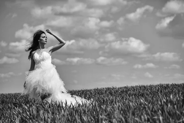 Mooie bruiloft meisje op het groene gras en hemel — Stockfoto