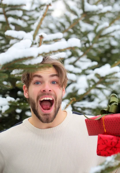 Macho shouting with presents on winter day — Stock Photo, Image