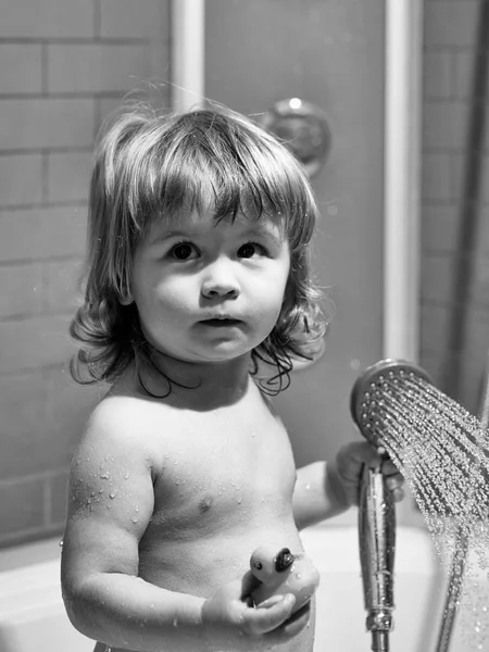 Boy with duckling in bath — Stock Photo, Image