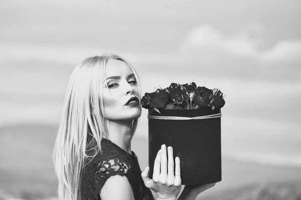 Woman with flowers in box — Stock Photo, Image