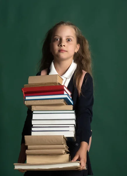 Kid with ponytails and plenty of textbooks for school — Stock Photo, Image