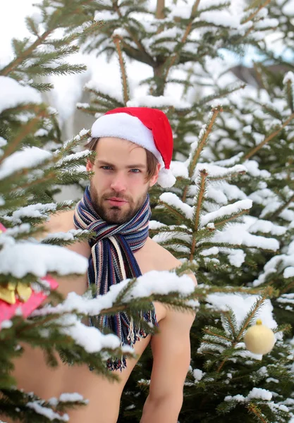 Man in kerstmuts en sjaal op naakte torso staande — Stockfoto