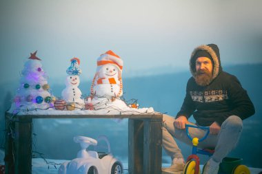 Mutlu hipster kar üzerinde üç tekerlekli bisiklet sürme