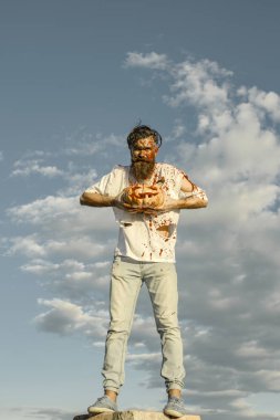 Cadılar Bayramı hipster üzerinde gri gökyüzü yüksek ayakta kabak ile