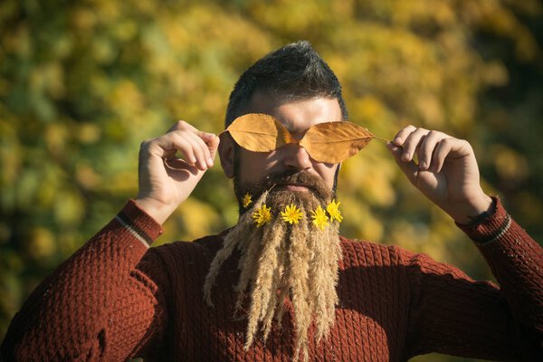 man with autumn leaves and beard of spikelet and dandelion s