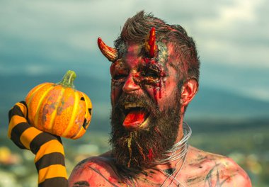 Cadılar Bayramı şeytan adam kabak içinde çizgili çorap holding