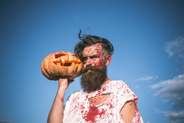 Halloween zombie with red blood and bloodstains on blue sky