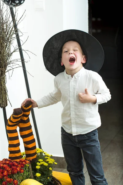 Halloween Small boy in spider web hat at striped socks. — Stock Photo, Image