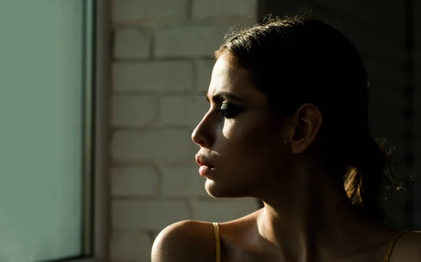 Girl or woman with face profile look at window — Stock Photo, Image