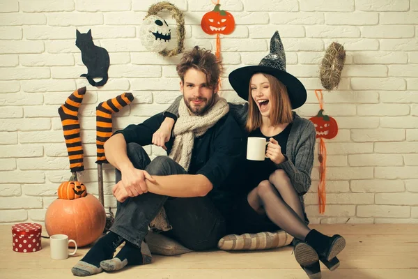 Halloween couple in love sitting on floor — Stock Photo, Image