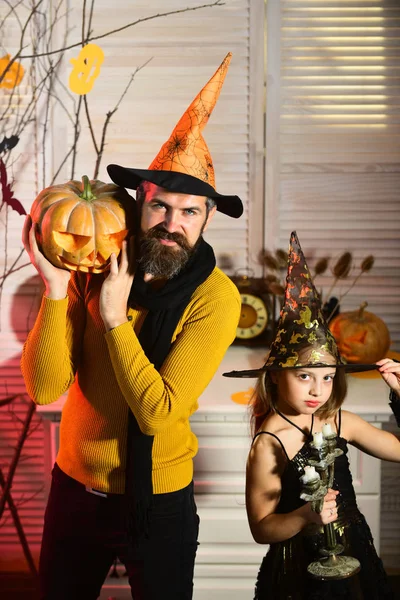 Papà e bambino con cappelli da strega tengono zucca e lampadario . — Foto Stock