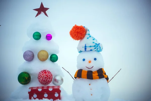 Snowman with smiley face in hat and scarf — Stock Photo, Image