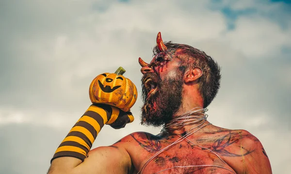 Halloween satan with open mouth, beard, red blood, wounds