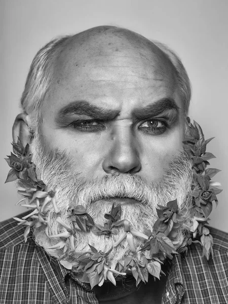 old man with flowers and leaves in beard