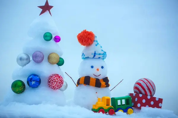 Snowman with smiley face in hat and scarf — Stock Photo, Image