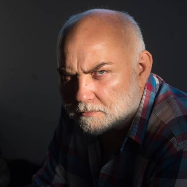 Gri sakallı, çatık kaşları ciddi yüz