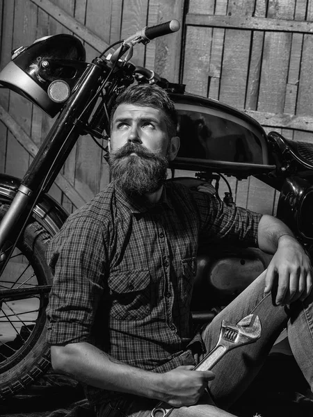 Bearded biker man with wrench — Stock Photo, Image