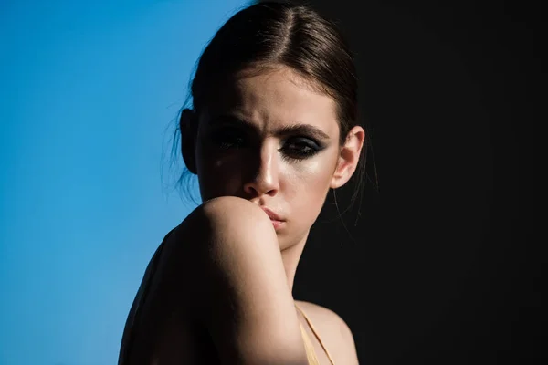 Woman with eyeshadow makeup on black and blue background — Stock Photo, Image