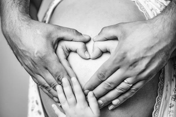 Hands make heart on belly — Stock Photo, Image