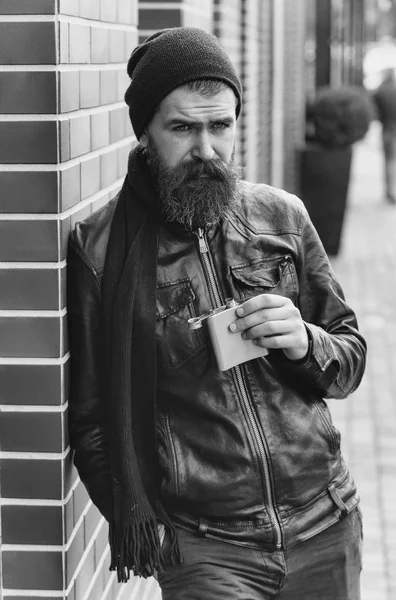 Serious bearded man hipster with metallic jar in leather jacket — Stock Photo, Image