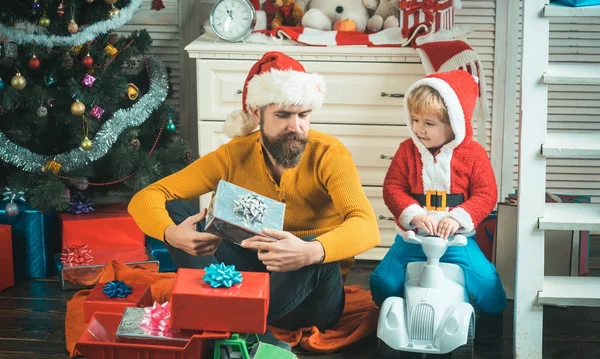 Christmas happy child and father with gift box, boxing day.