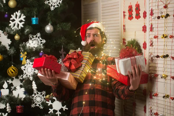 New year guy with illuminated wire , present box and toy. — Stock Photo, Image