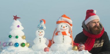 Şapkalar ve kar kardan adam xmas ağacı üzerinde mavi gökyüzü