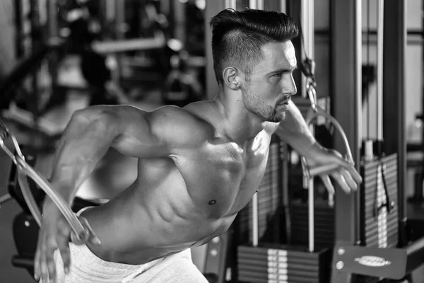 Musculoso hombre entrenamiento en gimnasio —  Fotos de Stock