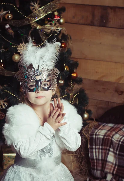 Christmas happy child in white dress and mask. Stock Picture