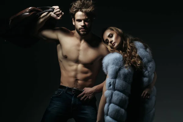 Macho with travel bag and girl in fur vest