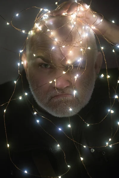 Christmas garland at face of man with beard, new year — Stock Photo, Image
