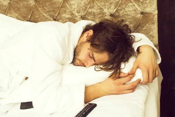 Bearded man on bed with remote — Stock Photo, Image