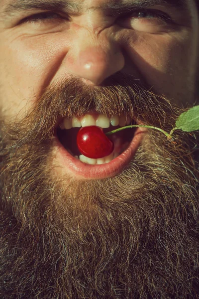 bearded man with red cherry