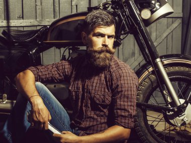 bearded biker man with wrench clipart