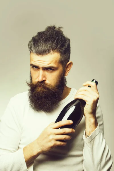 bearded man with wine bottle