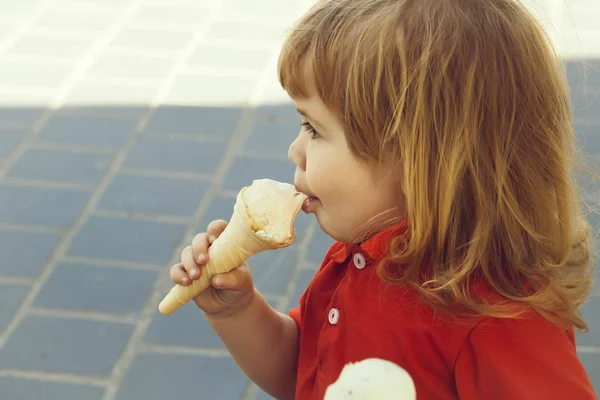 Small boy eating ice cream
