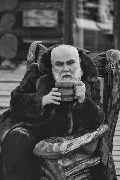 Bearded cook with wooden cup — Stock Photo, Image